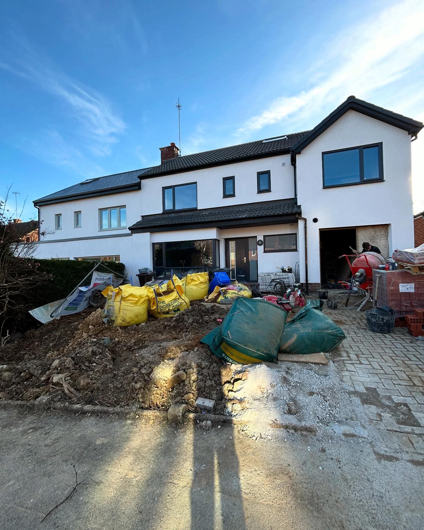 A full house rendering project partway through, with materials on site