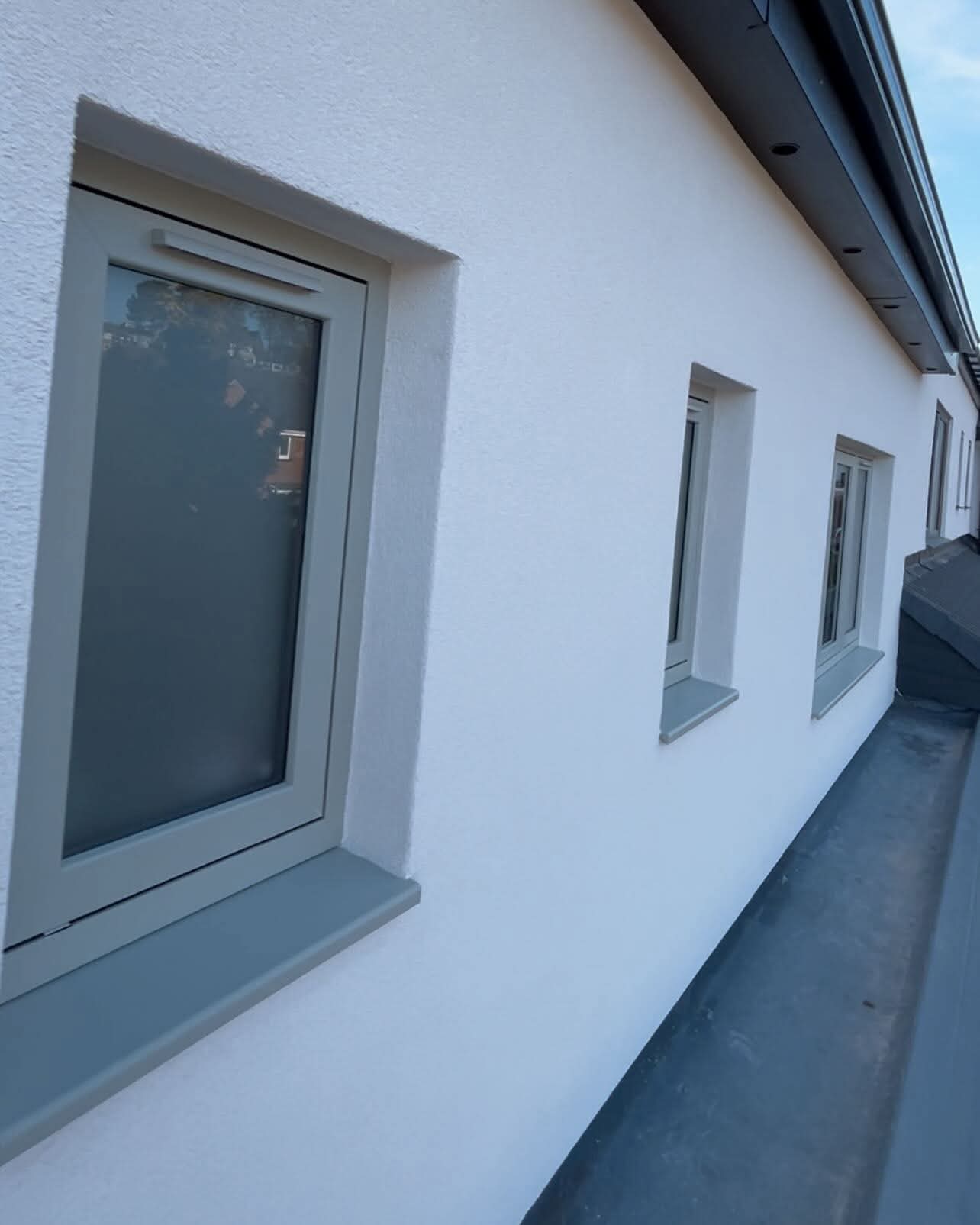 Close-up of a smooth render finish around new window surrounds